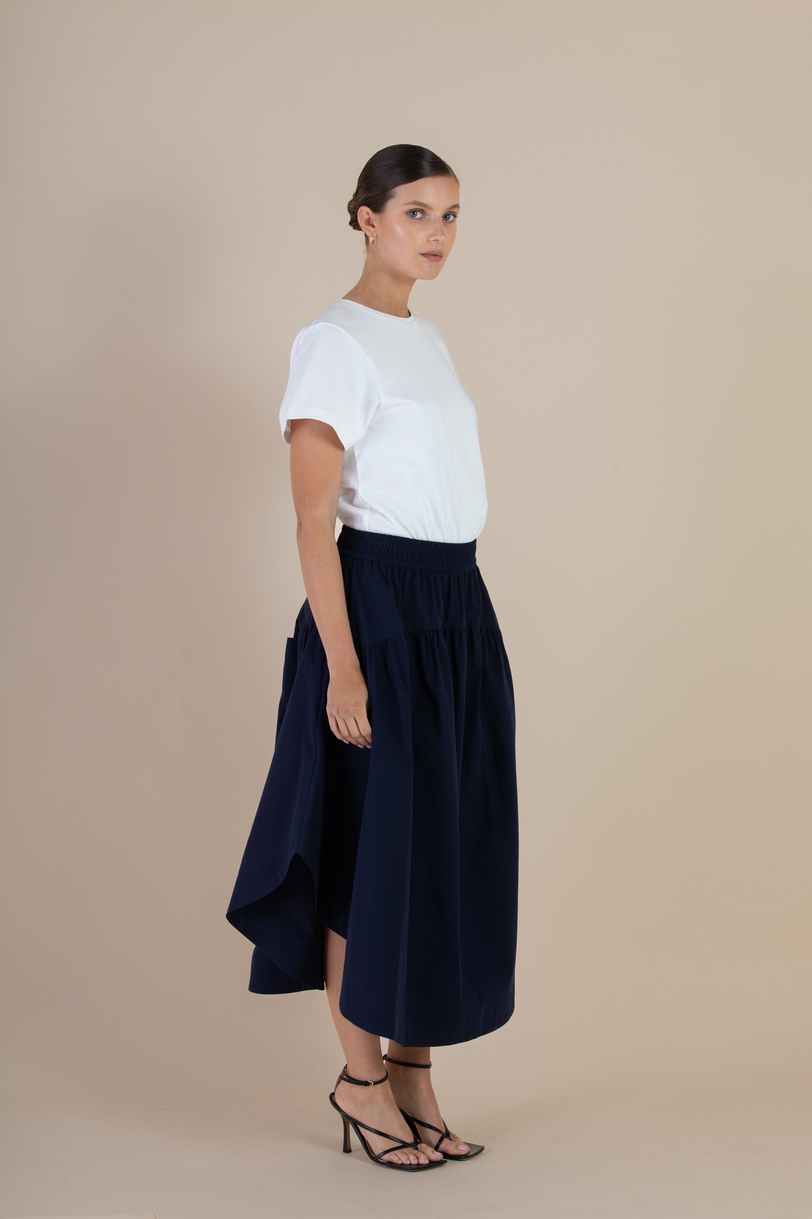 Side view of the SELFE Sawyer Skirt in Midnight – elevated skirt with fluid drape and tailored finish